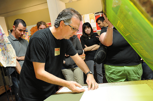 Jeff preps the table and lines up the paper to be printed on. 